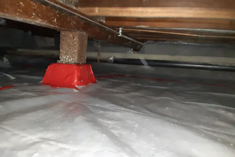 New vapor barrier with piers wrapped and sealed.