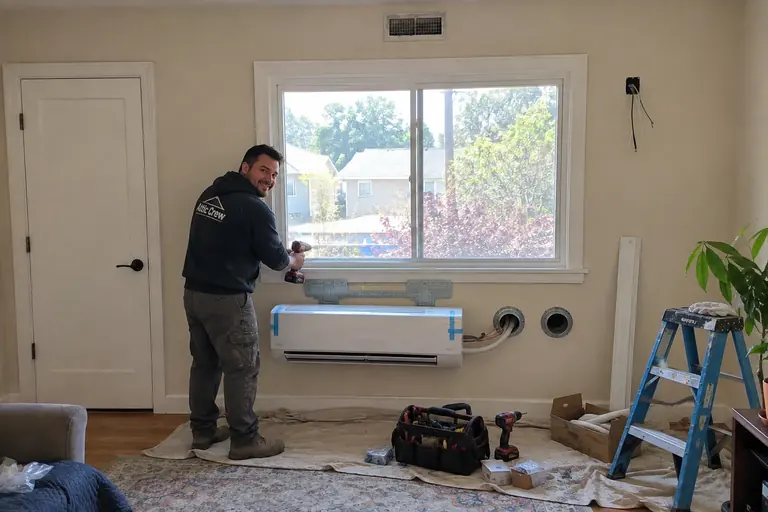 Ductless mini-split installation, in progress: Mounting the ductless indoor unit below the window.