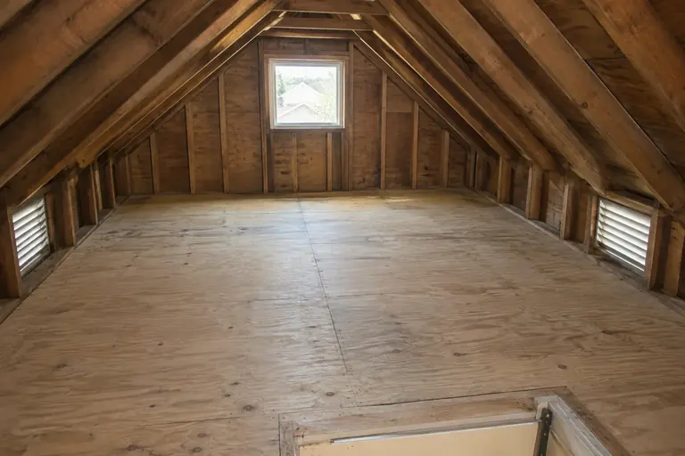 Rodent-damaged attic cleaned out, after: Attic floor cleared, sanitized and ready for new insulation.
