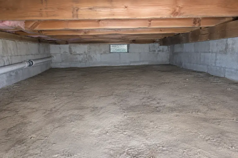 Block-wall crawl space cleanout, after: Crawl space cleared and sanitized.