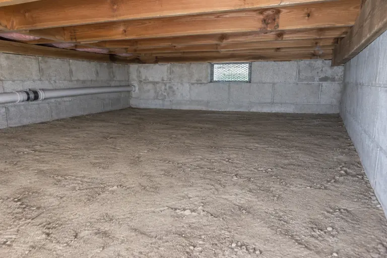 Block-wall crawl space cleanout, finished detail: Cleared floor along the foundation wall and vent.