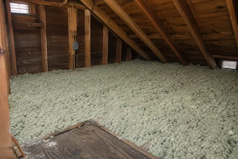Pink batts replaced with blown-in insulation, after: New blown-in insulation at an even depth.
