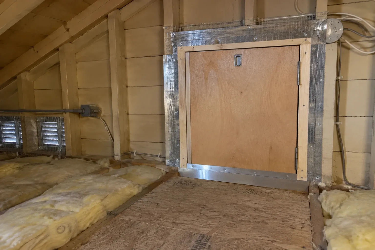 After: Hatch frame sealed with steel mesh and sheet-metal flashing, insulation refitted.