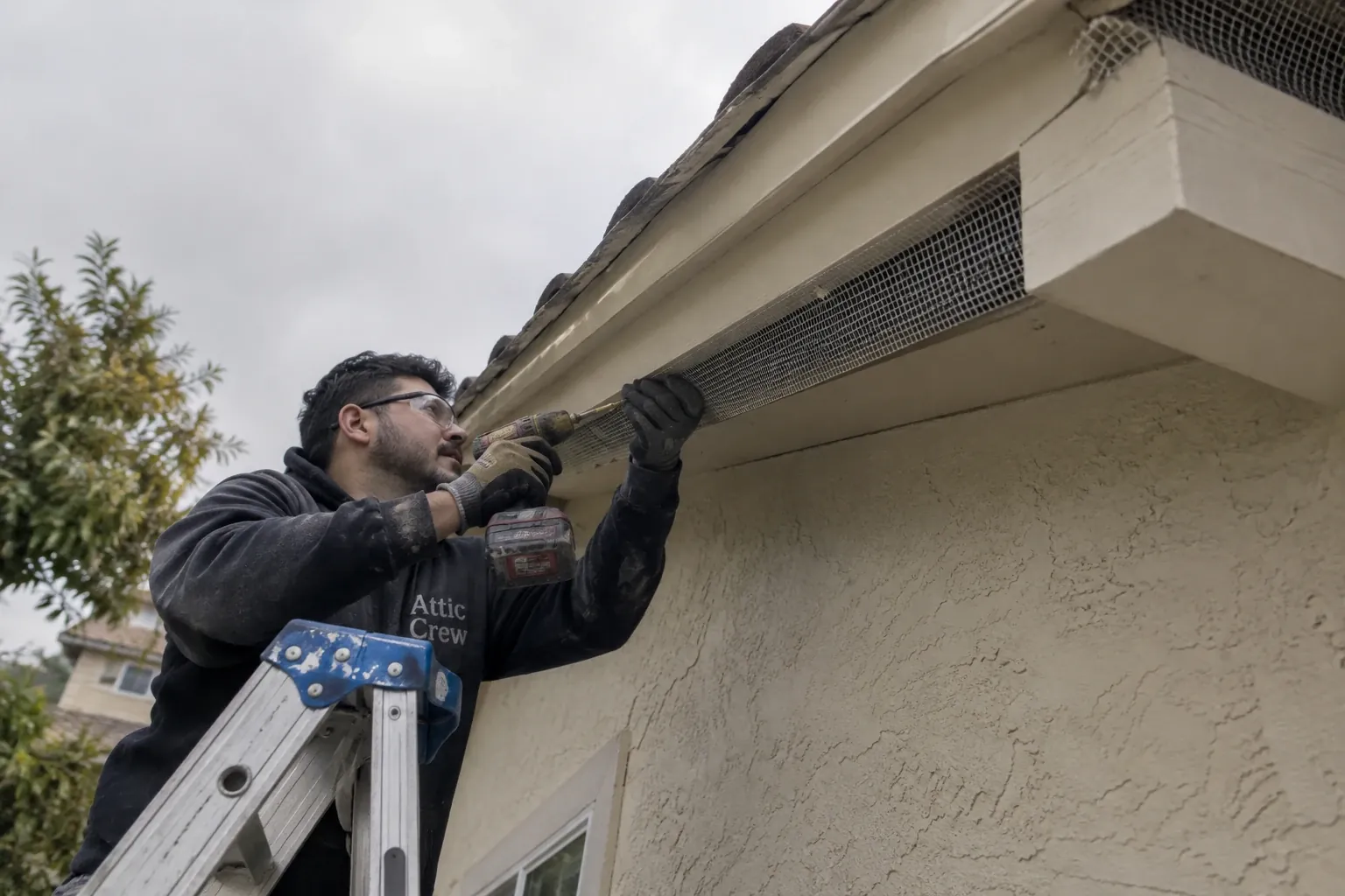 Sealing gaps along the eaves from a ladder.